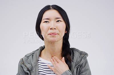 Buy stock photo Asian woman, sore throat and virus in pain, allergies or bacteria against a white studio background. Sick Japanese female person touching neck from cough, allergy or flu of cold, illness or infection