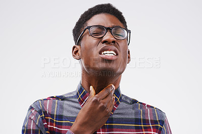Buy stock photo Studio shot of a young man suffering with a sore throat against a grey background