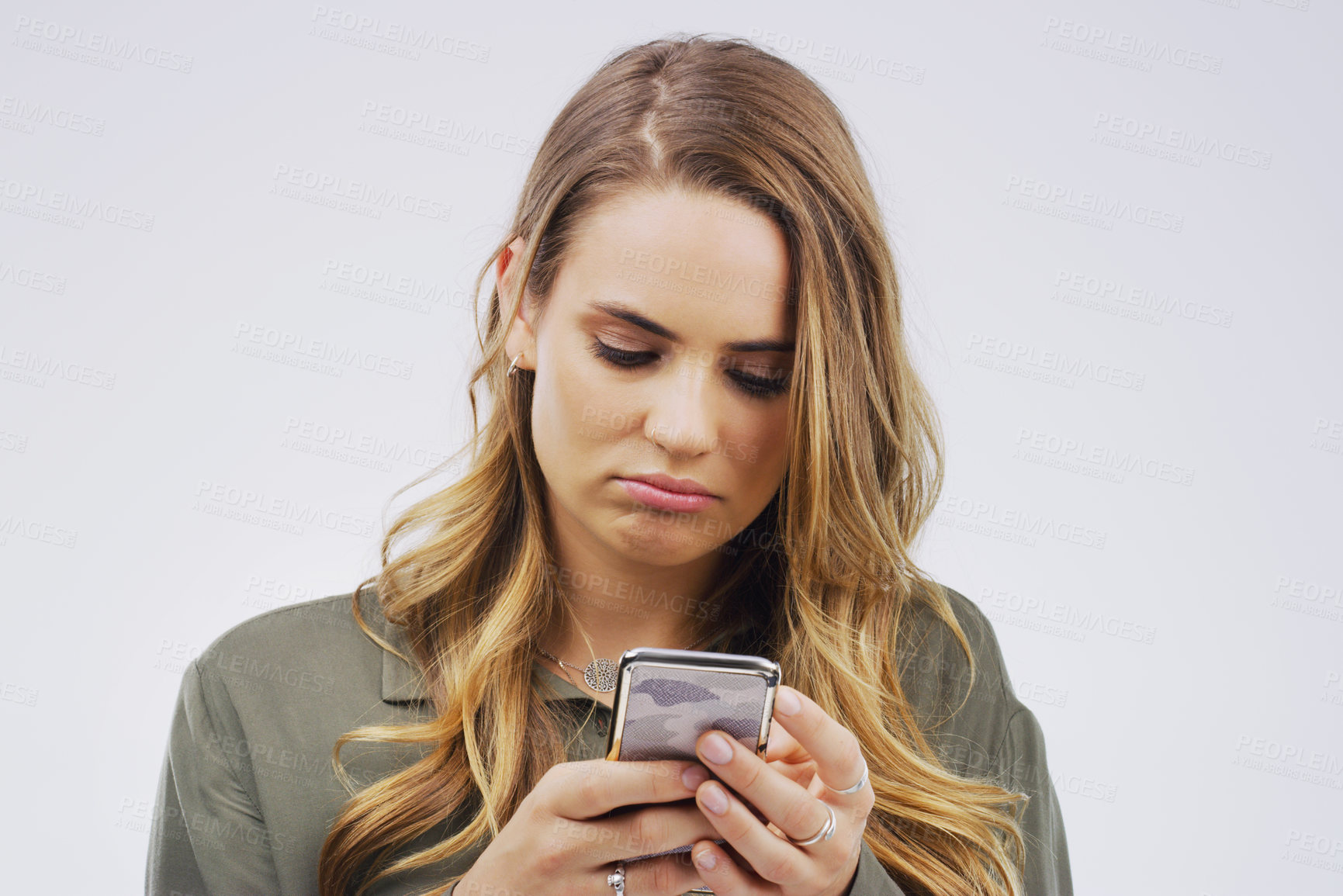 Buy stock photo Woman, depression and sad with smartphone for social media post in grey background, technology and emotion. Girl, mental health and stress for marriage, anxiety and browsing on web app or internet