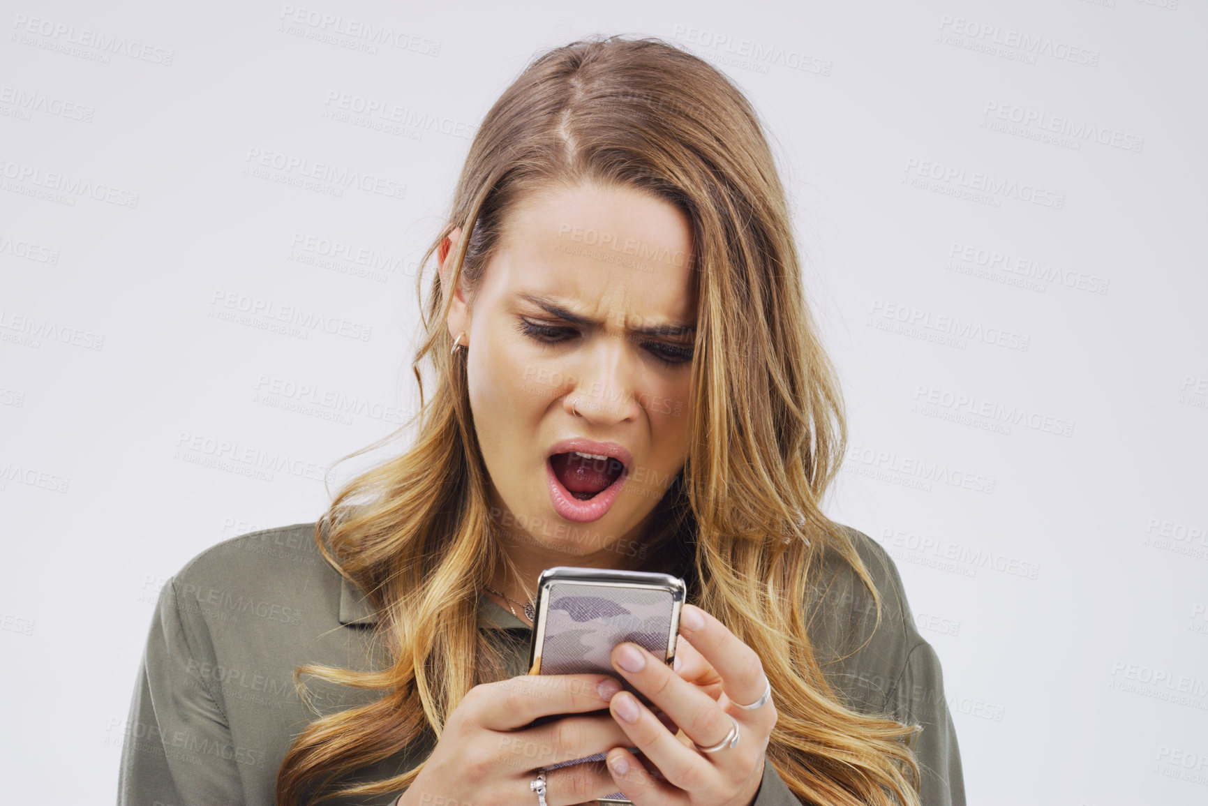 Buy stock photo Woman, omg face and smartphone on studio background for reading article with wow expression, social media and online scam. Male person, mobile and surprise by grey backdrop for news website and shock