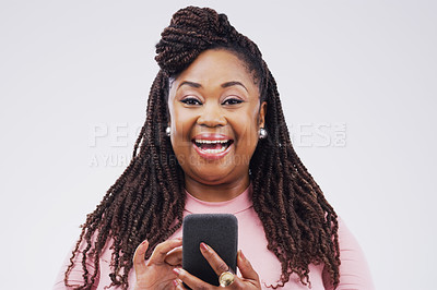 Buy stock photo Studio shot of a happy young woman using her cellphone