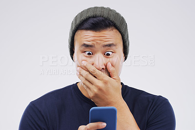 Buy stock photo Asian man, surprise and phone in shock for winning, prize or good news against a white studio background. Shocked or surprised male person reading on mobile smartphone in wow for lottery competition