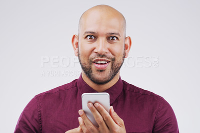 Buy stock photo Man, surprise and smartphone in studio portrait for social media post, text message or online blog. Male person, mobile and wow by white background for internet news, omg and website notification