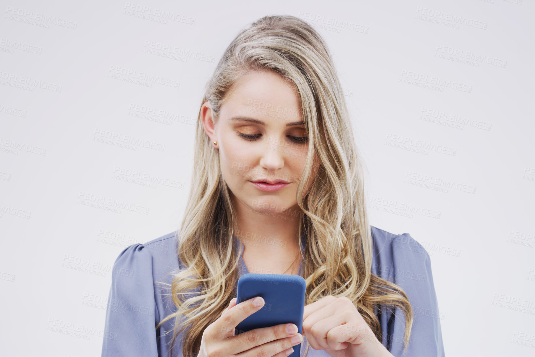 Buy stock photo Business woman, phone and typing in studio, networking and check email or reading notification. Female person, communication and app to chat to contact, b2b connection and website for economy update