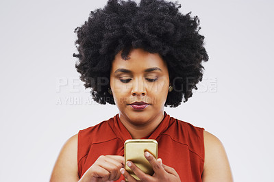 Buy stock photo Studio shot of a beautiful young woman using her cellphone against a grey background