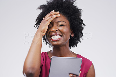 Buy stock photo Studio shot of a young woman using a digital tablet against a grey background