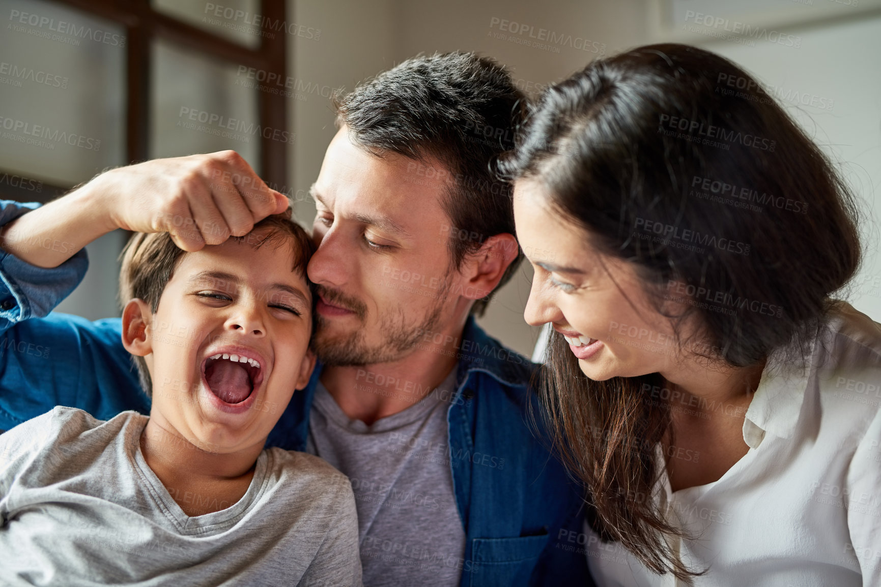 Buy stock photo Family, playful and bonding in home with mother, parents and son together. Love, smile and father relax with mama and happy child in house bedroom with support and care for childhood fun and growth