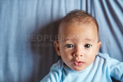 Buy stock photo Portrait of an adorable baby boy laying on the bed at home