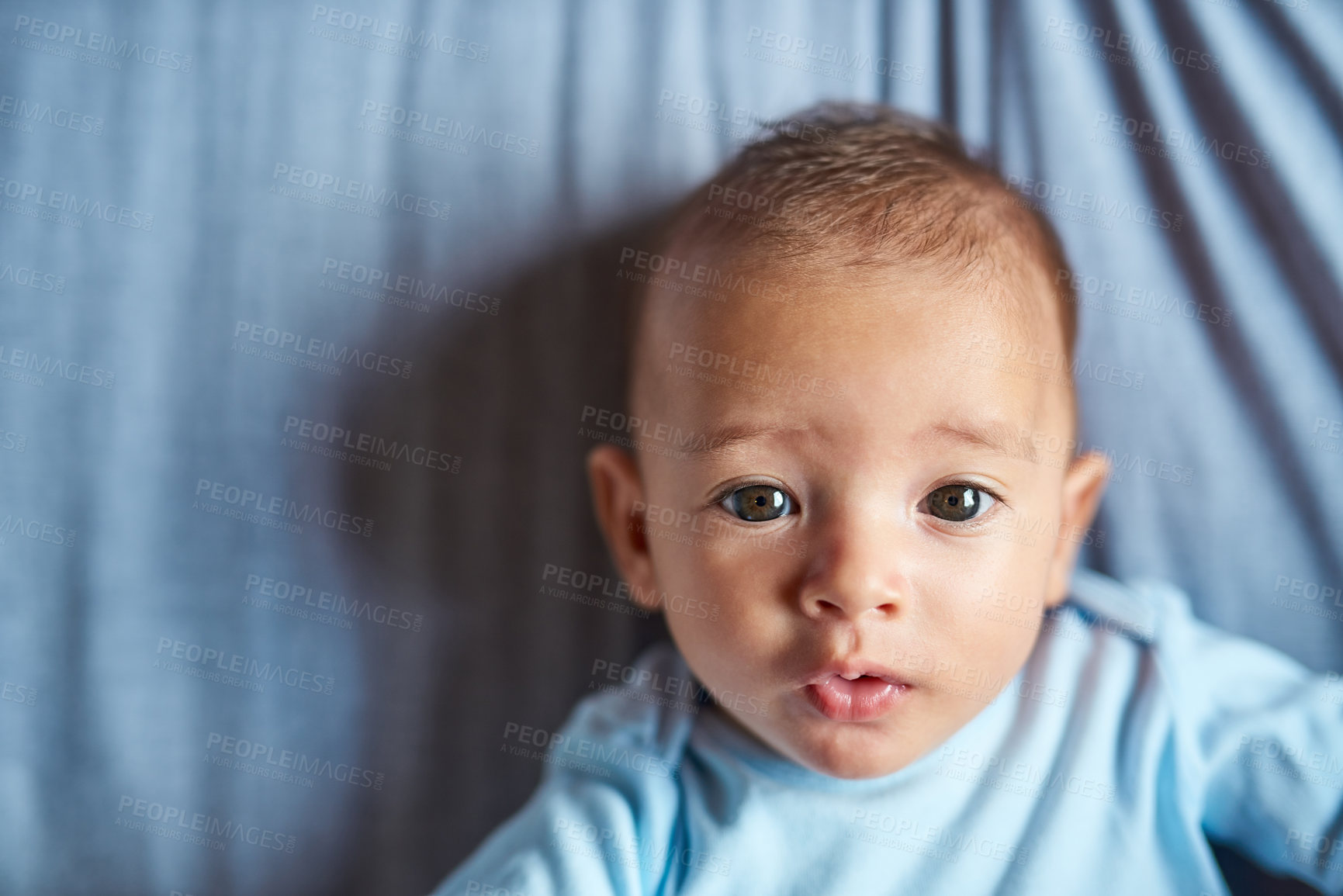 Buy stock photo Portrait of an adorable baby boy laying on the bed at home