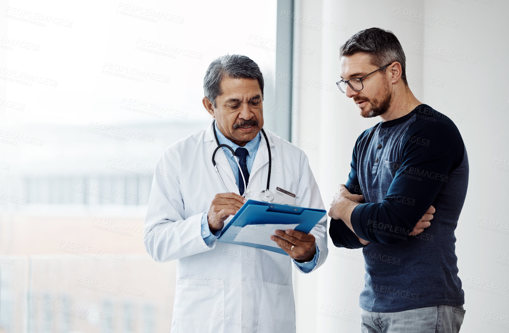 Buy stock photo Healthcare, documents and a doctor with a man patient in the hospital talking during a consulting checkup. Medical, health and wellness with a medicine professional speaking to a client in a clinic