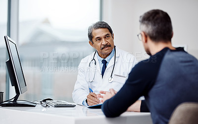 Buy stock photo Healthcare, office and doctor in a consultation with a patient in discussion on a diagnosis in the clinic. Professional, career and mature male medical worker talking to man in the medicare hospital.