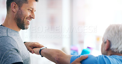 Buy stock photo Shot of a male doctor doing some physiotherapy with a senior patient