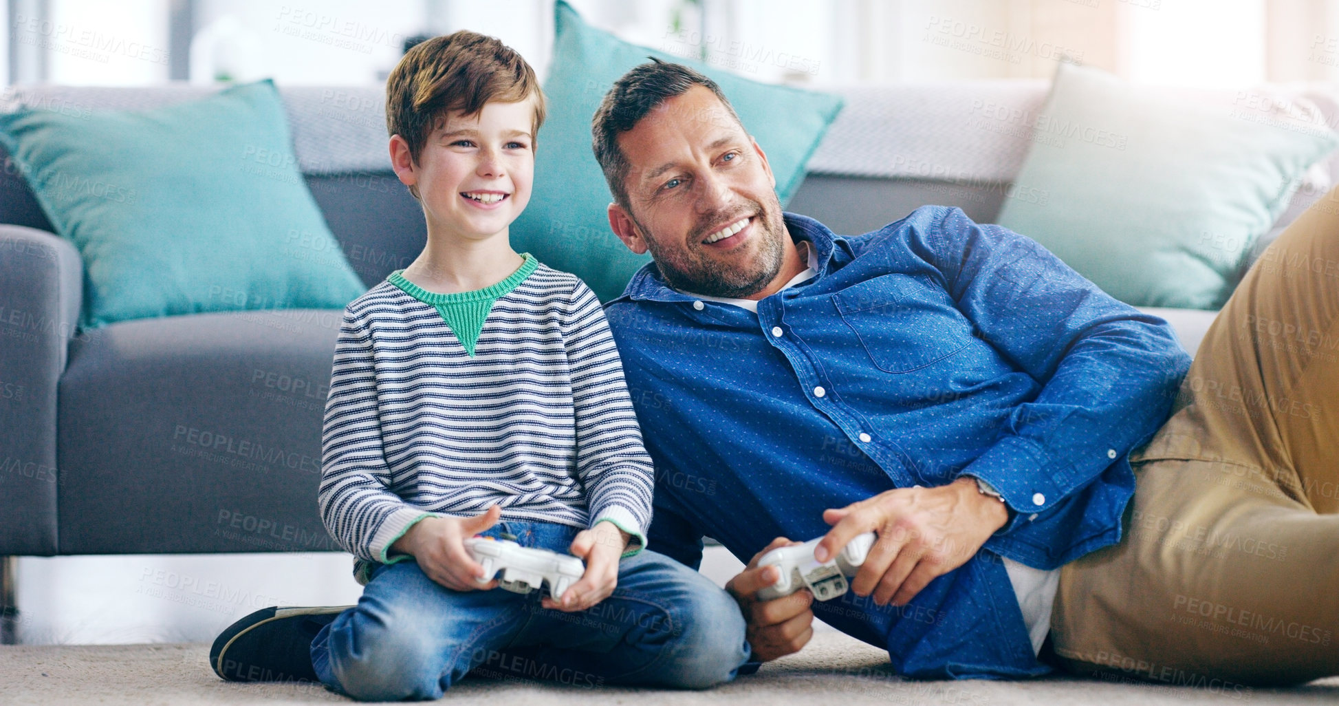 Buy stock photo Happy father, child and playing video games for fun bonding, holiday or weekend together on the living room floor at home. Dad and kid smiling in joyful happiness for console gaming or entertainment