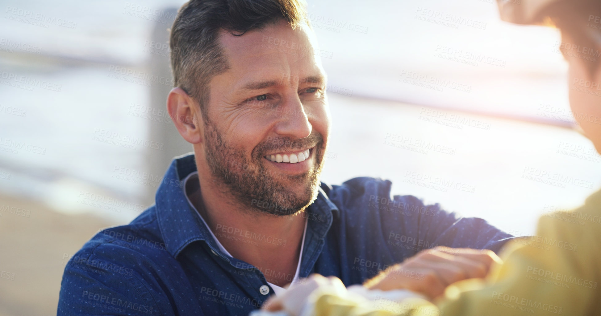 Buy stock photo Closeup shot of a cheerful father teaching his son how to ride a bicycle outdoors