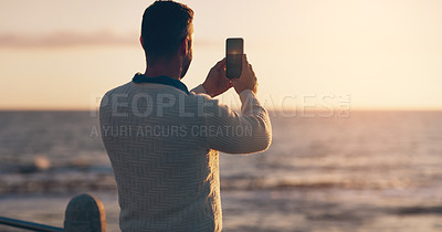 Buy stock photo Man, phone and photography for sunset by ocean on vacation with memory, post and horizon in summer. Person, smartphone and memory for profile picture with water, sea and waves for social media app