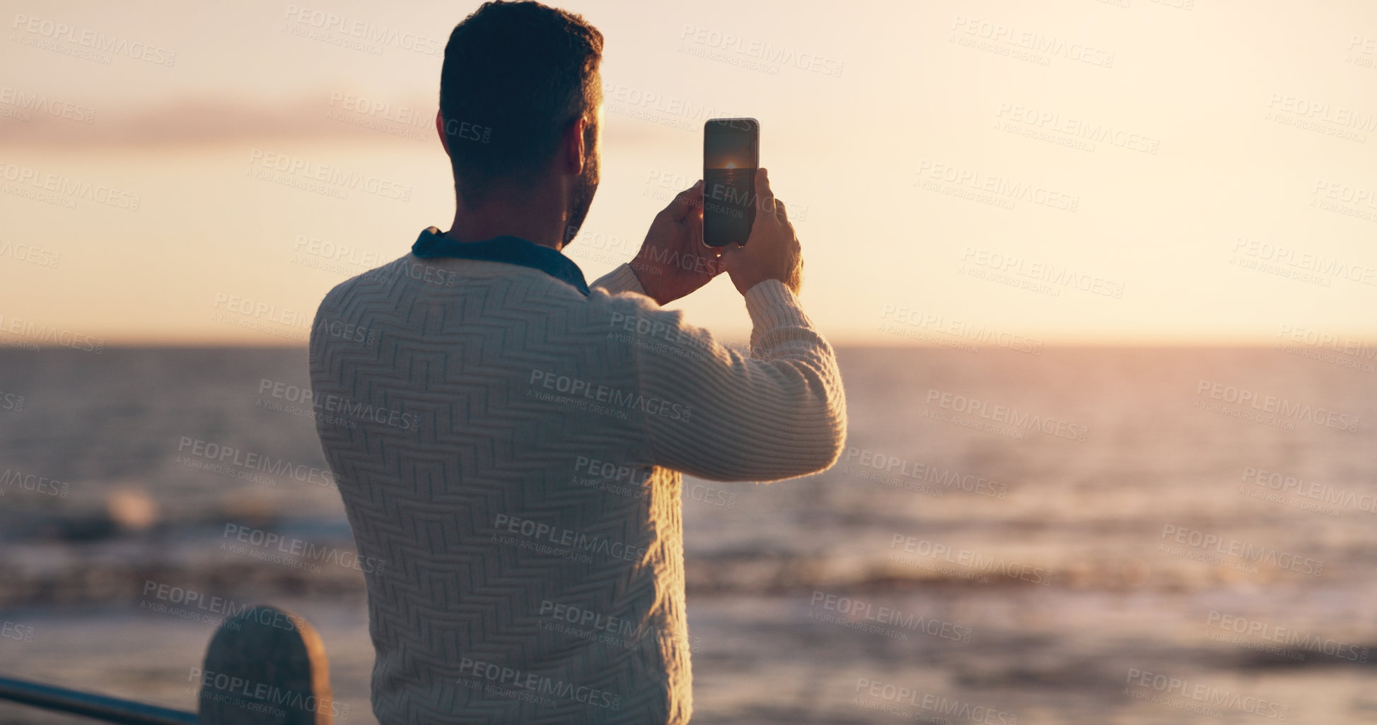 Buy stock photo Man, phone and photography for sunset by ocean on vacation with memory, post and horizon in summer. Person, smartphone and memory for profile picture with water, sea and waves for social media app