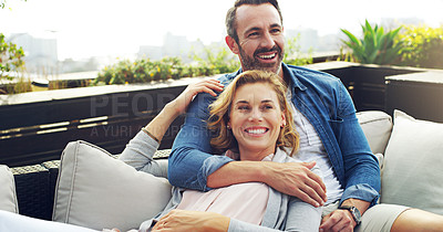 Buy stock photo Embrace, relax and couple on hotel terrace with smile, love and tropical holiday fun together. Laughing, man and happy woman on outdoor couch with hug, cozy romance and date on calm travel vacation.
