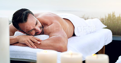 Buy stock photo Man, spa and relax on massage table outdoor at holiday resort, vacation and peace at hotel. Mature male person resting on beauty salon bed for body cosmetics, luxury service and calm muscle therapy