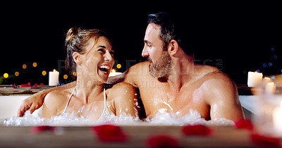 Buy stock photo Spa, love and couple in a jacuzzi happy, smile and relax one date night at a wellness resort. Zen, hot tub and man with woman laughing, peace and enjoying a romantic vacation, holiday or anniversary