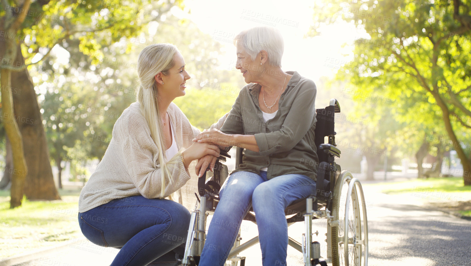 Buy stock photo Happy, wheelchair and a mother and woman in a park for support, bonding and talking. Smile, family love and an elderly mom with a disability and a girl in nature for conversation and happiness