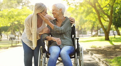 Buy stock photo Hug, woman and senior mother at the park, wheelchair and happiness with joy, weekend break or bonding. Family, mature parent or daughter embrace, outdoor or relax with a smile, disability or recovery