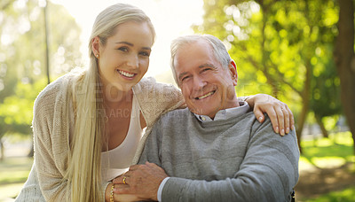 Buy stock photo Cropped portrait of an affectionate young woman embracing her aged father at the park