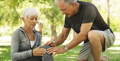 Buy stock photo Old couple, woman with knee pain and injury in park, fibromyalgia health problem and joint ache from exercise. Man helping, arthritis and people in retirement with fitness outdoor and muscle tension