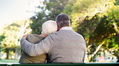 Buy stock photo Hug, bench and a senior couple outdoor in a park with love, care and support in marriage. Back of elderly man and woman together in nature for quality time, healthy retirement and freedom to relax