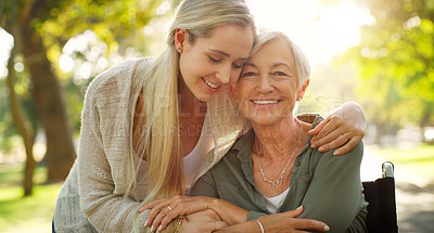 Buy stock photo Cropped shot of an affectionate young woman embracing her aged mother at the park