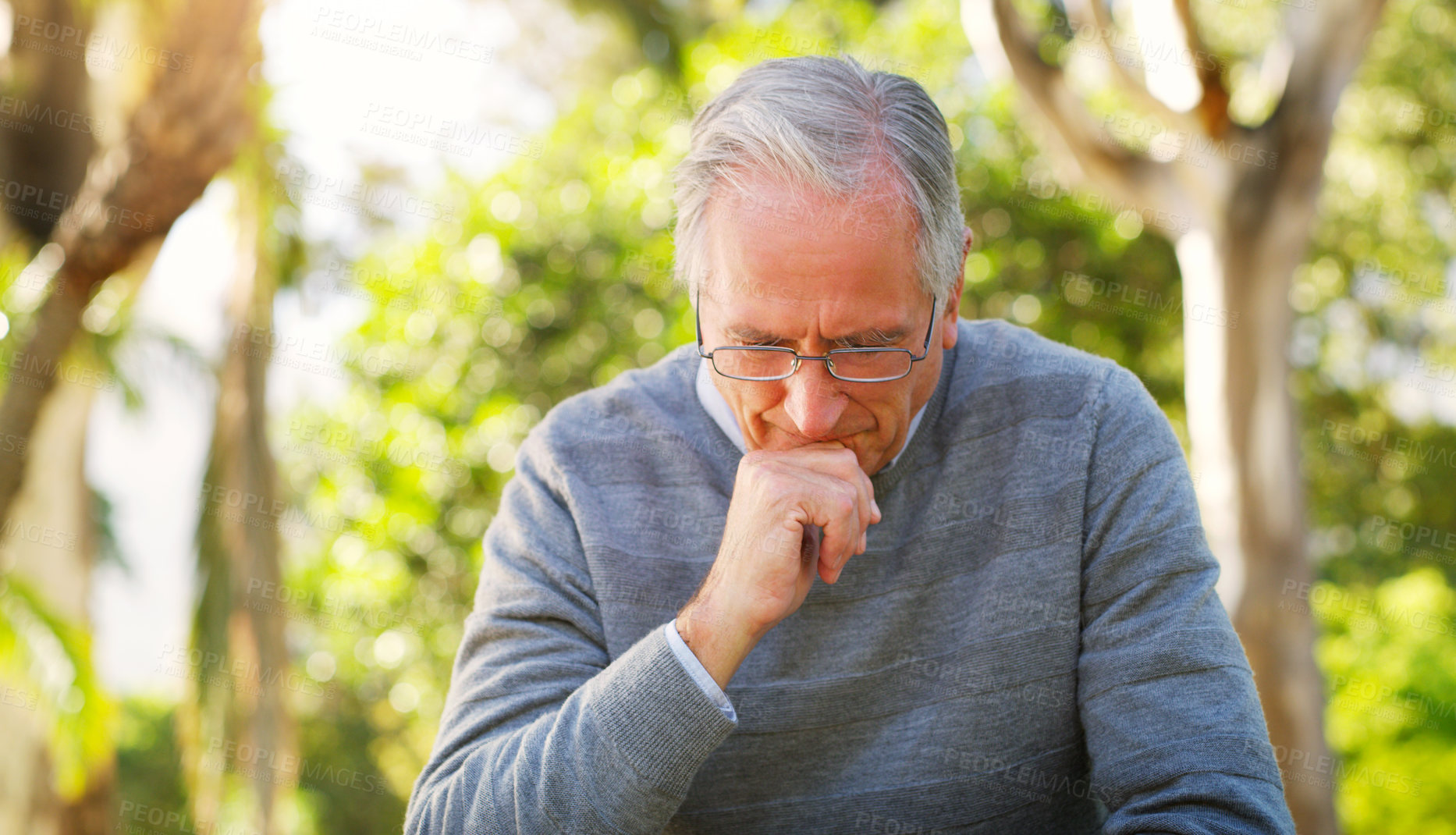 Buy stock photo Depression, park and senior man crying while sitting on a bench thinking on mental health problem. Nature, outdoor and sad elderly male person in retirement with grief stress after loss in a garden.