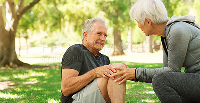 Buy stock photo Old couple, man with knee pain and injury outdoor, fibromyalgia health problem and joint ache from exercise. Woman helping, arthritis and people in retirement with fitness in park and mockup space