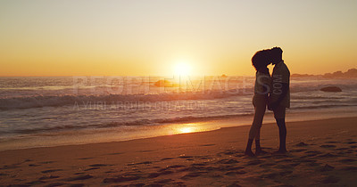 Buy stock photo Sunset, kiss and silhouette of couple at the beach for bonding, date or holiday in Bali. Care, dark and a man and woman kissing at the ocean together for love, romance or vacation freedom by the sea