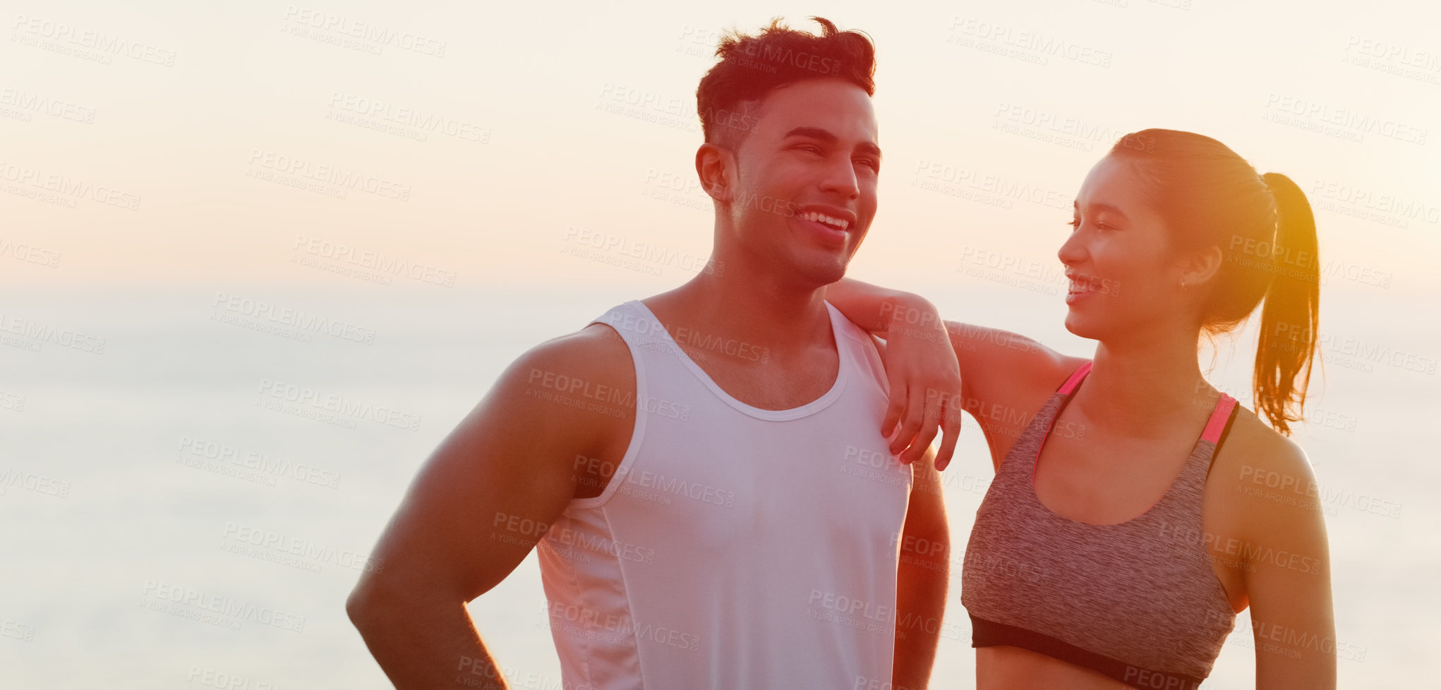 Buy stock photo Cropped shot of an affectionate young couple looking happy while working out outdoors
