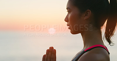 Buy stock photo Cropped shot of an attractive young woman practicing yoga outdoors at sunset