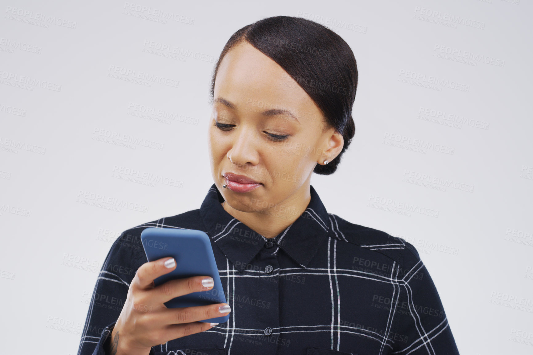 Buy stock photo Studio shot of a young woman using a mobile phone against a grey background