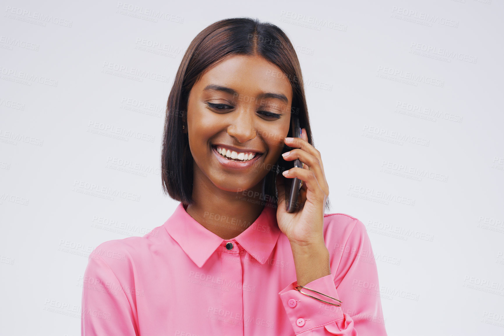 Buy stock photo Phone call, laugh and Indian woman in studio smile for conversation, talking and funny chat. Communication mockup, white background and female person on smartphone for network, contact and connection