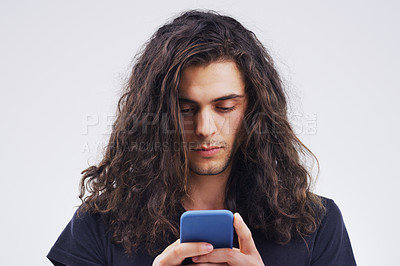 Buy stock photo Phone, communication and face of man in studio typing for social media post, internet and online chat. Mockup, white background and male person on smartphone for website, mobile app and networking