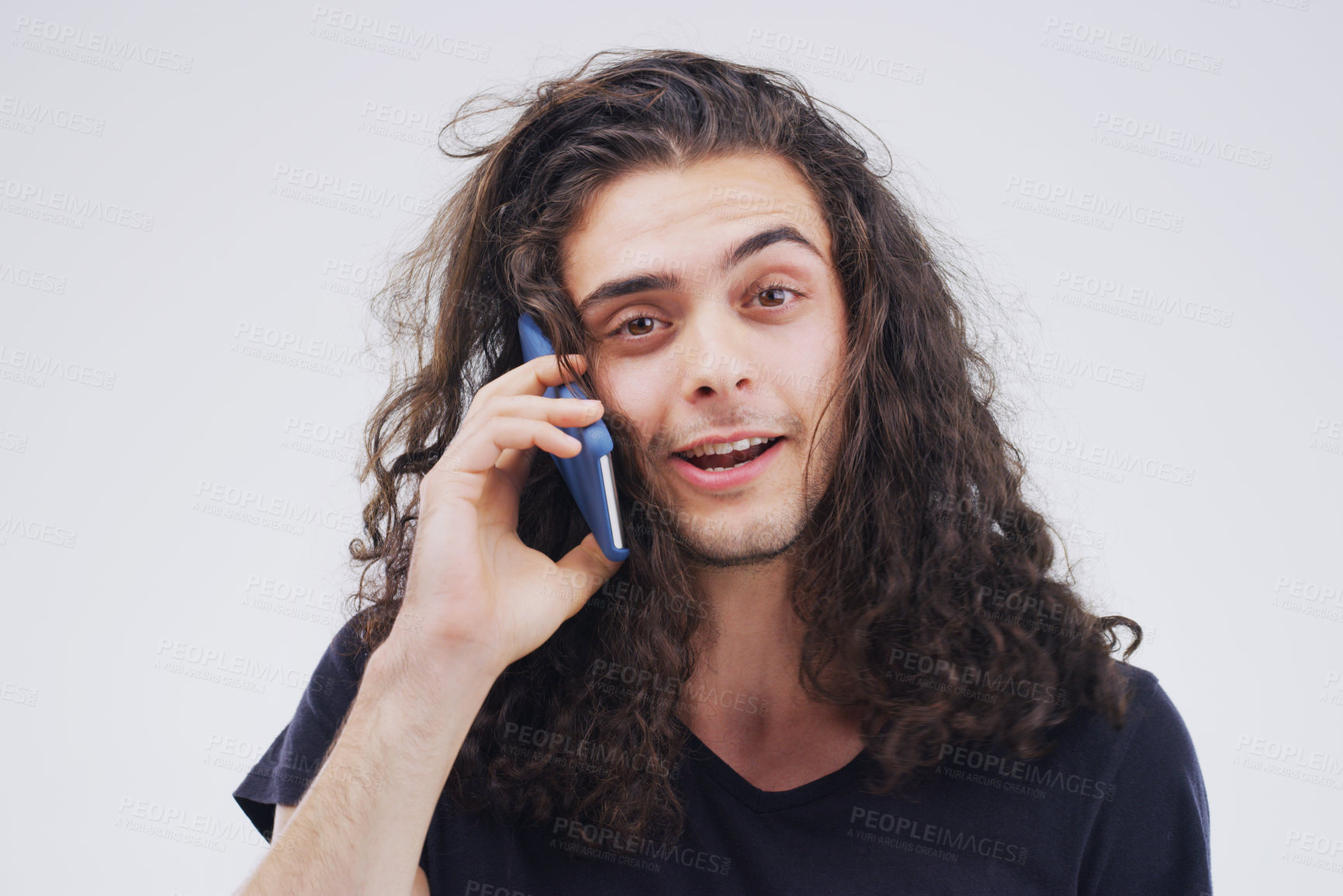 Buy stock photo Studio shot of a young man using a mobile phone against a grey background