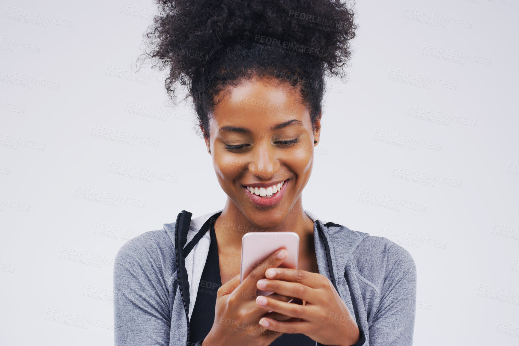 Buy stock photo Phone, happy and African woman typing in studio with smile for social media, internet and online chat. Communication, white background and female person on smartphone for website, mobile app and text