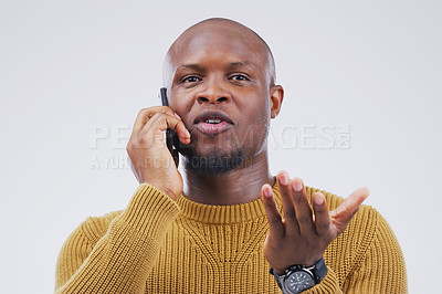 Buy stock photo Studio shot of a young man using a mobile phone against a grey background