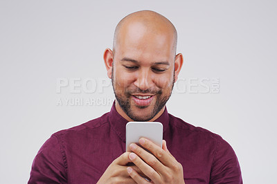 Buy stock photo Phone, typing and man in studio with smile for social media, internet and online chat. Communication, white background and happy male person on smartphone for website, mobile app and text message