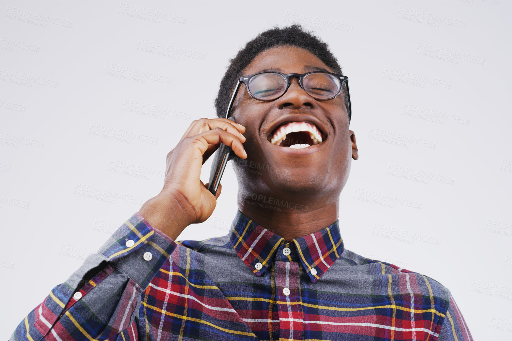 Buy stock photo Phone call, laugh and happy black man in studio for conversation, talking and funny chat. Communication mockup, white background and male person on smartphone for network, contact and connection