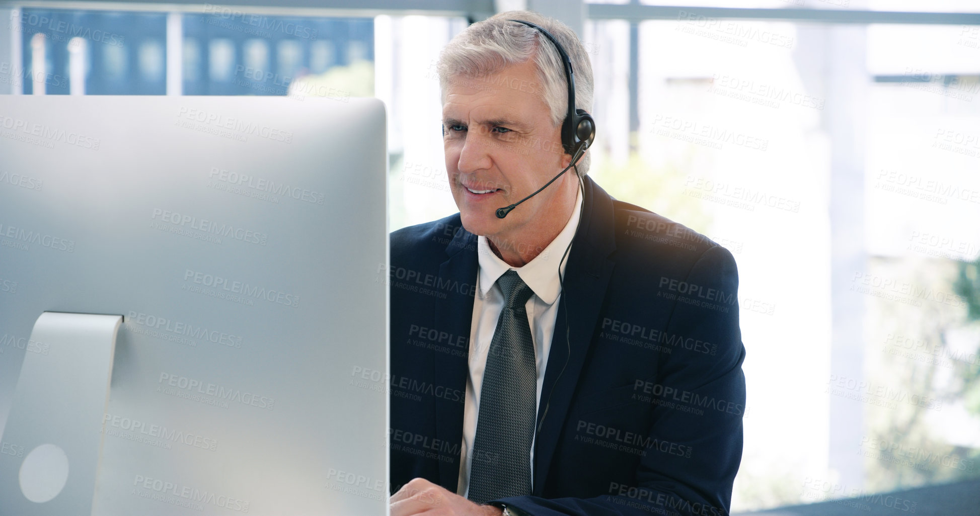 Buy stock photo Video call, computer and a mature business man using a headset in the office during an online meeting. Desktop, smile communication with a senior male manager or CEO in an online training webinar