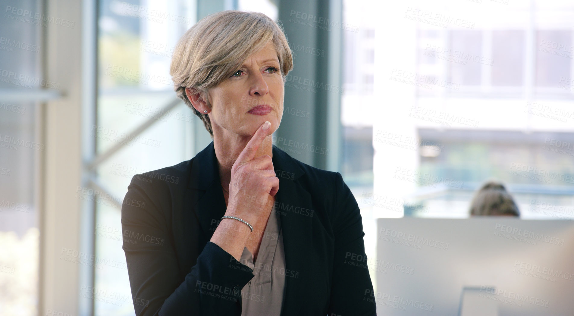 Buy stock photo Shot of a mature businesswoman looking thoughtful in an office