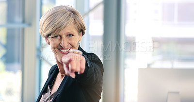 Buy stock photo Portrait of a mature businesswoman pointing to the camera in an office