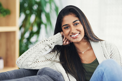 Buy stock photo Cropped portrait of a happy young woman relaxing on the couch at home