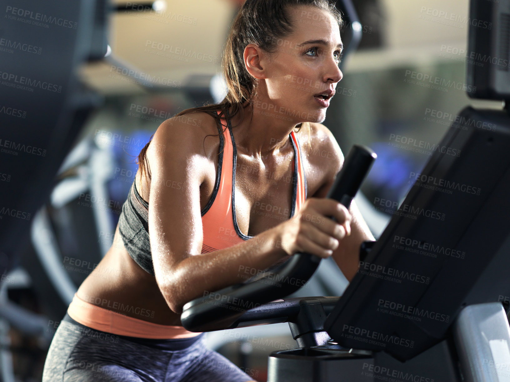 Buy stock photo Woman, marathon training and elliptical machine with fitness in gym for health, cardio endurance and wellness. Cyclist, exercise bike and performance on equipment, workout sweat and power challenge