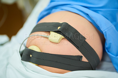 Buy stock photo Shot of an unrecognizable pregnant woman lying in her hospital bed on her due date