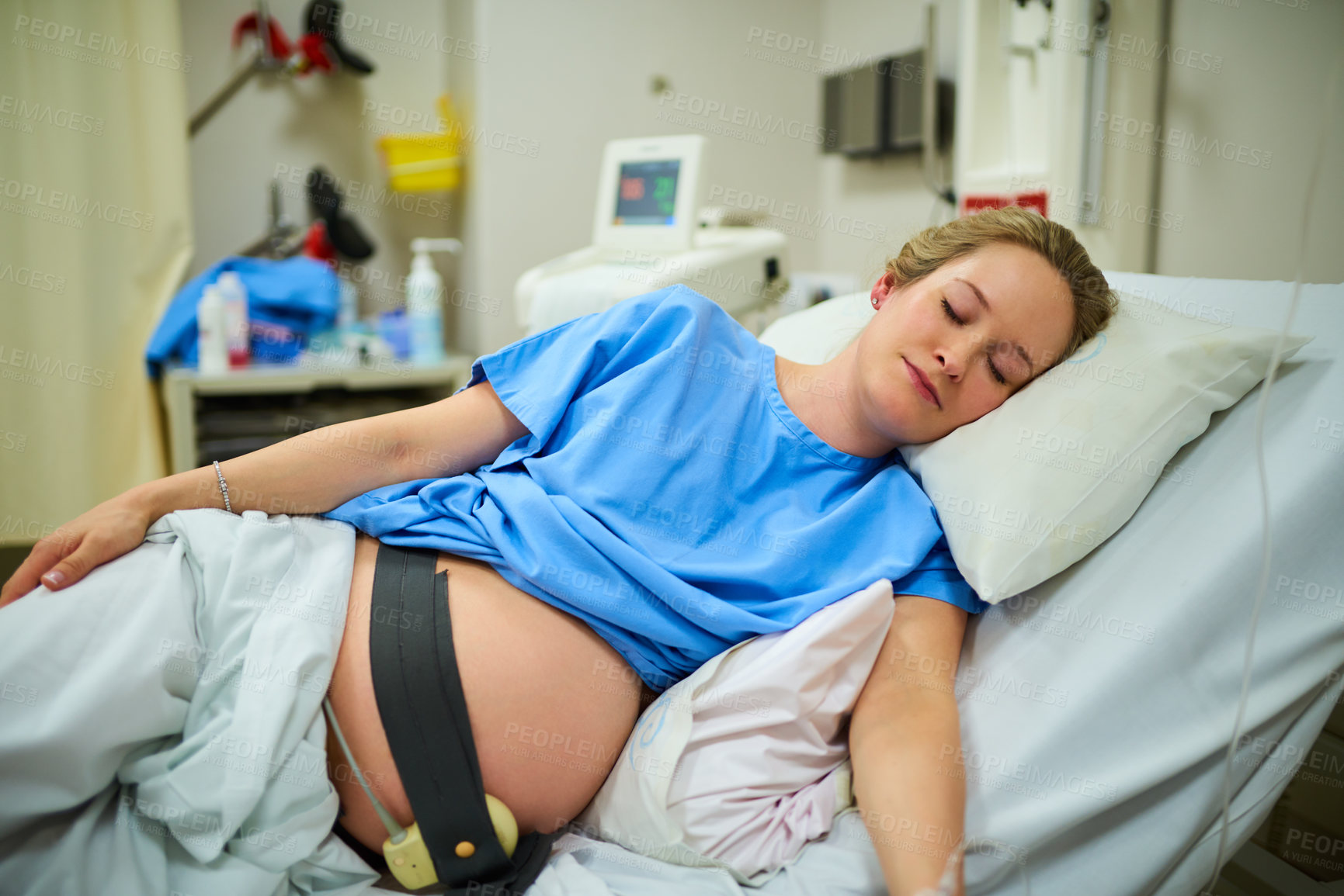 Buy stock photo Shot of an attractive young pregnant woman sleeping in her hospital bed