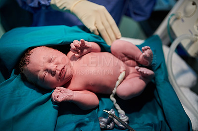 Buy stock photo Shot of a newly born baby girl surrounded by medical staff in the hospital